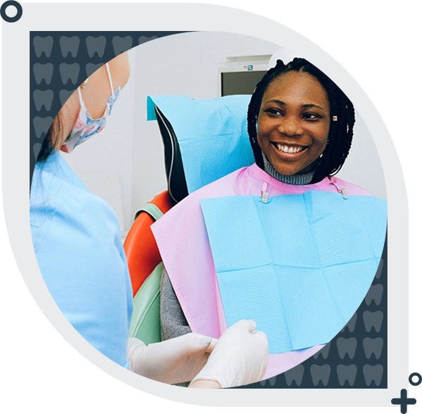 A woman sitting in the dentist chair smiling.