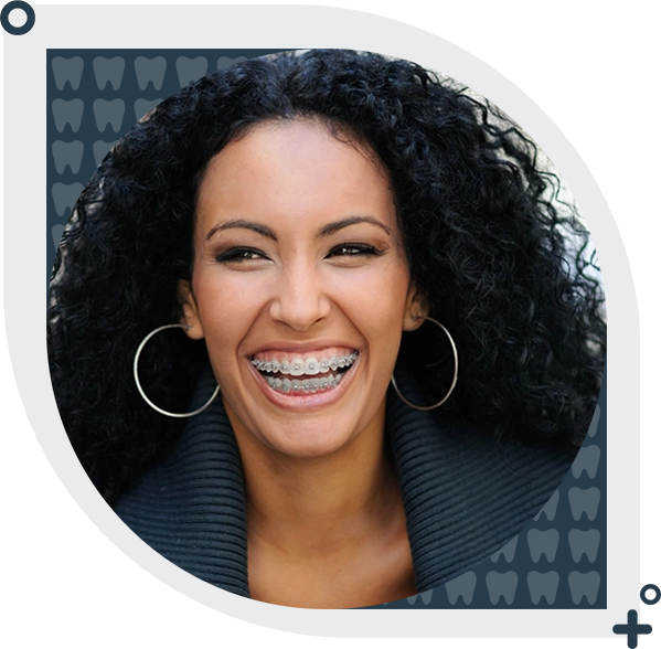 A woman with braces smiles for the camera.